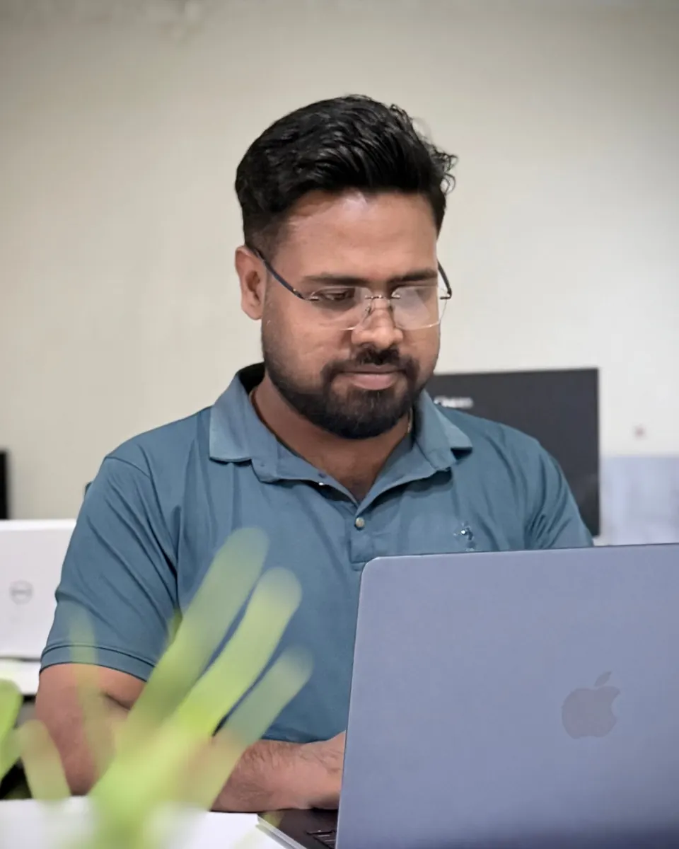 KMR Jibon at his laptop in the Softvole office