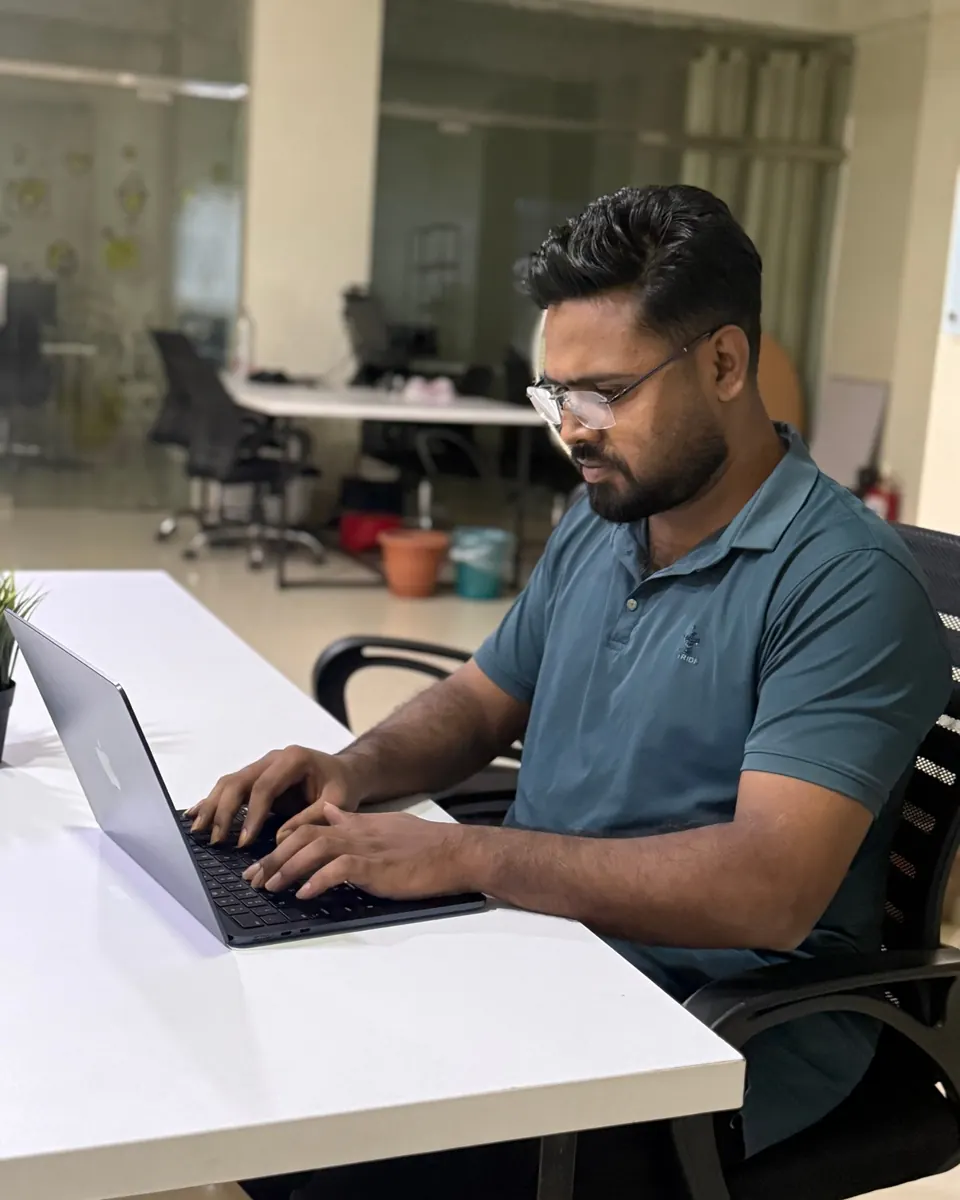 KMR Jibon typing on a laptop in the office
